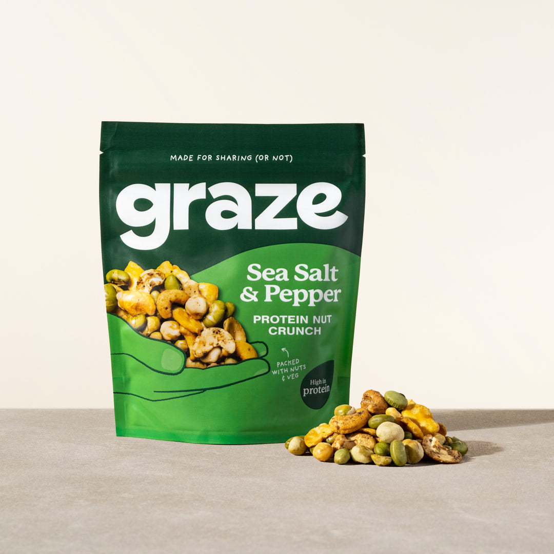 a sharing bag of graze sea salt and pepper nut crunch snack next to a small pile of the product
