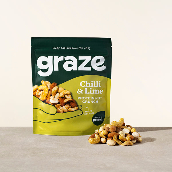 a sharing bag of graze chilli and lime protein nut crunch snack next to a small pile of the product