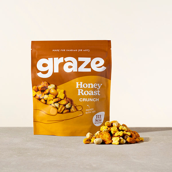 a sharing bag of graze honey roast crunch snack next to a small pile of the product