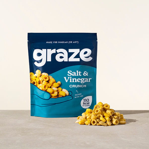 a sharing bag of graze salt and vinegar crunch snack next to a small pile of the product