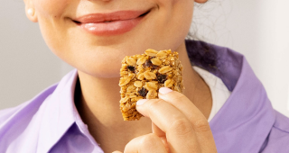 A woman eating a Graze oat boost