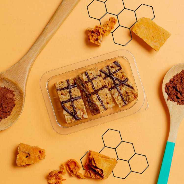 honeycomb flapjack in a punnet with scattered honeycomb pieces 